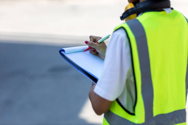 istock Hand holding checklist for writing and checking in goods in container at Container cargo site. 1401210799