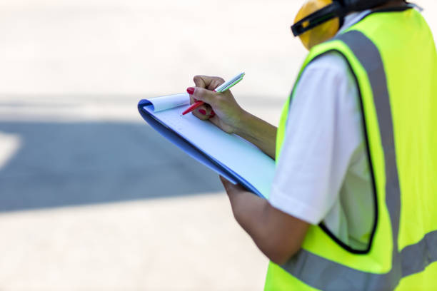 istock Hand holding checklist for writing and checking in goods in container at Container cargo site. 1401210800