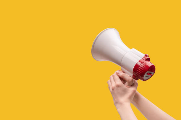 istock Megaphone in woman hands on a white background. 1401210902