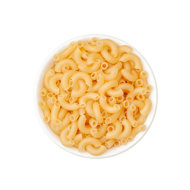 istock Italian pasta coquillette in white cup isolated on white background. View from above 1401211169
