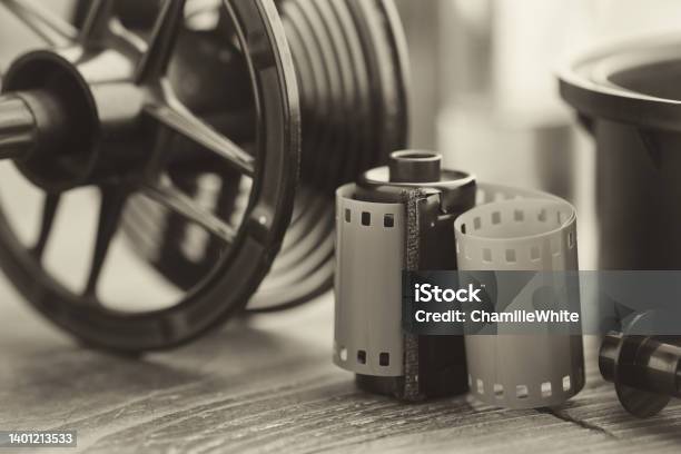 Photo Film Roll And Cassette Photographic Equipment Developing Tank With Its Film Reels On Background Selective Focus Retro Black And White Photo Stock Photo - Download Image Now