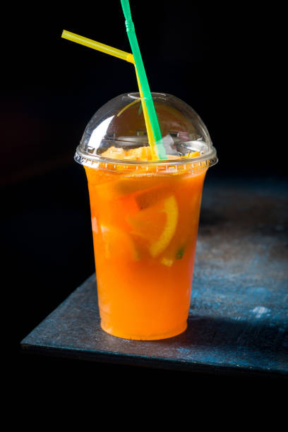 istock Orange lemonade with orange slices on dark style on dark blue table 1401215690