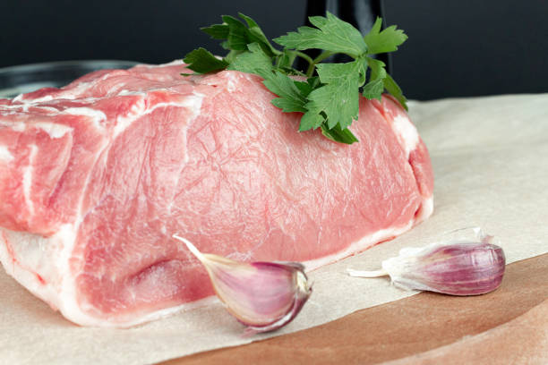 istock Raw meat steaks with garlic and meat knife, on kitchen cutting board. 1401216709