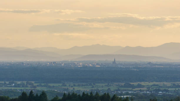 Distant view of city Strasbourg, France including popular cathedral and Vosges mountains in background from Black Forest, Germany stock photo