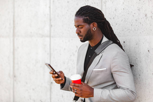 istock Portrait of a young handsome man using a smartphone during an outdoor coffee break 1401219202