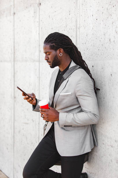 istock Portrait of a young handsome man using a smartphone during an outdoor coffee break 1401219214