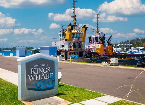 Royal Naval Dockyard, Bermuda-May 22, 2022- Two powerful tug boats are moored to Kings Wharf in Bermuda, at the ready to assist large cruise ships to safely dock or leave this busy island port of call.