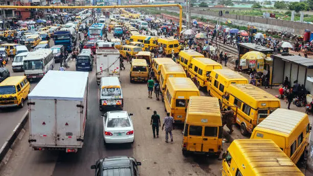 Yellow public transport danfos in traffic.
Lagos, Nigeria, West Africa