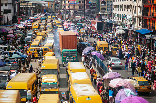 Yellow public transport danfos in traffic.
Lagos, Nigeria, West Africa
