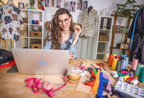 istock Fashion designer working on laptop in studio 1401228998