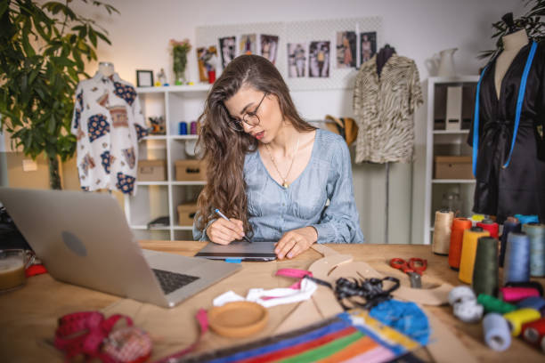 istock Fashion designer working on laptop in studio 1401229086