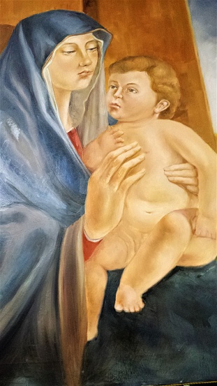 Virgin Mary with baby Jesus, held in her arms.