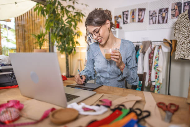 istock Fashion designer working on laptop in studio 1401229290
