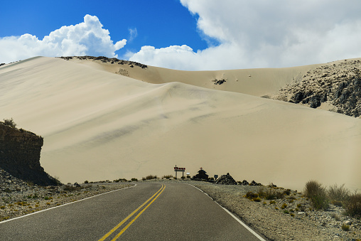 Sand dunes towering above the scenic Cuesta de Randolfo stretch of the Provincial Route 43, on the way to Antofagasta de la Sierra, Catamarca Province, Argentina