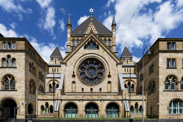 the cologne synagogue in neo-romanesque style in front of blue sky with clouds