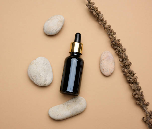 istock Brown glass bottle with a pipette stands on a brown background 1401233397