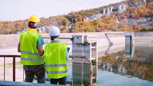 istock Maintenance engineers working in hydroelectric power station. Renewable energy systems. Gender blend. 1401239236
