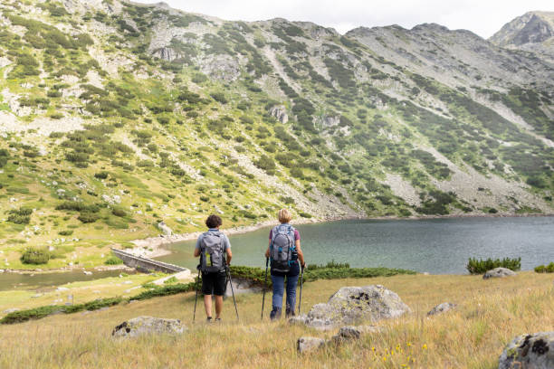 istock Two young adults exploring the mountain terrain 1401239292