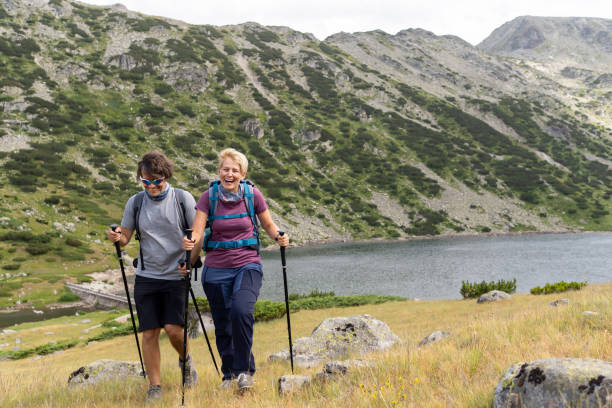 istock Two people using nordic sticks walking in the mountains 1401239299