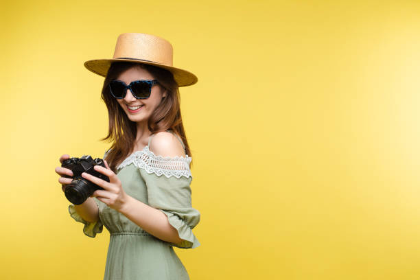 istock Young girl in straw hat and glasses keeping camera 1401239433