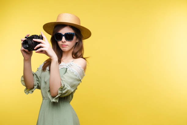 istock Young girl in straw hat and glasses keeping camera 1401239435