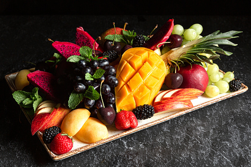 Mix of fresh ripe tropical fruits on plate.