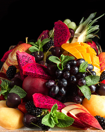 Mix of fresh ripe tropical fruits on plate.
