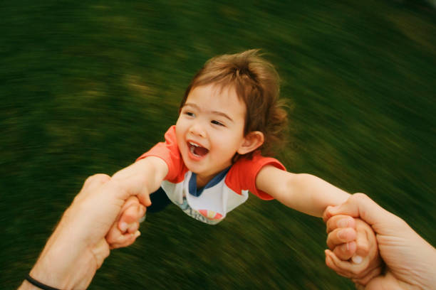 istock Toddler Swinging on Father's Arms 1401241407