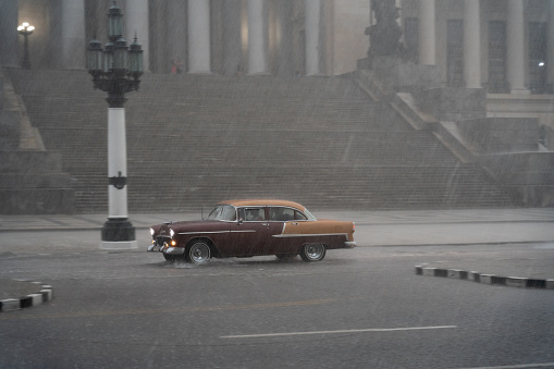 Typical old classic taxi in the streets of old Havana on a very rainy day. Cuba. Havana. Cuba. January 4, 2020.