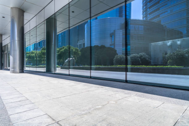 istock trees and buildings reflected on clean glass wall,china. 1401246074