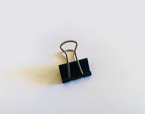 A binder clip, less commonly known as a paper clamp or foldover clip or bobby clip or clasp, is a simple device for binding sheets of paper together. The binder clip is in common use in the modern office.