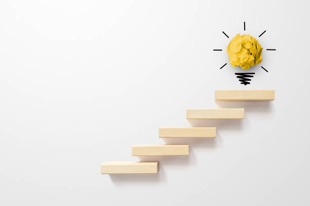 concept creative idea and innovation. paper scrap ball yellow colour with light bulb symbol on top step staircase growing growth - light bulb business wisdom abstract imagens e fotografias de stock