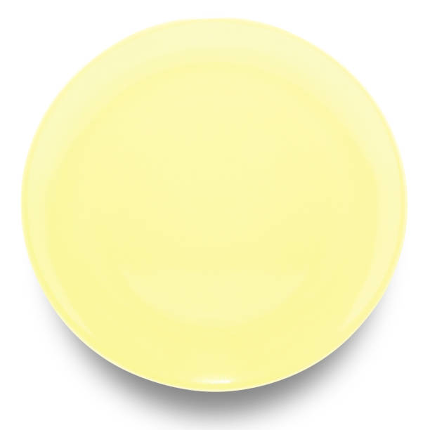 istock Yellow circle ceramics plate isolated on white background. 1401253790