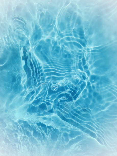 istock Defocus blurred transparent blue colored clear calm water surface texture with splashes and bubbles. Trendy abstract nature background. Water waves in sunlight. 1401253874