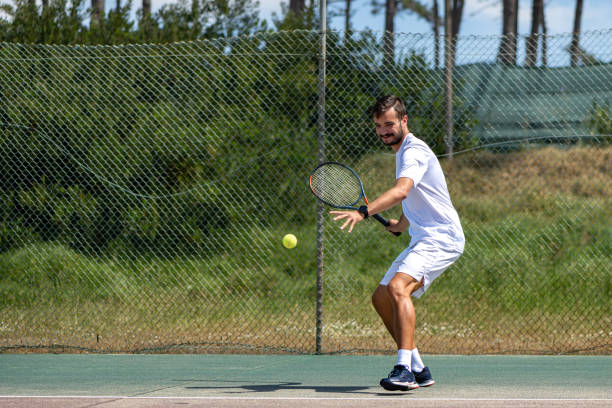 istock Tennis player hitting forehand at ball 1401256420