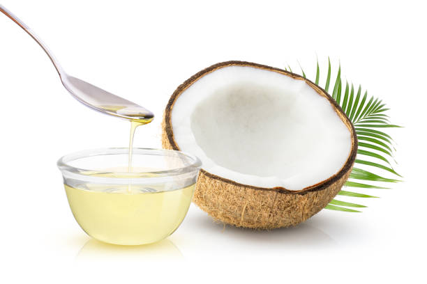 Coconut oil Coconut oil in glass bowl and coconut fruit with green leaves isolated on white background. coconut oil