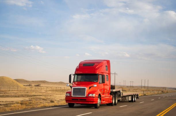 istock Red semi-truck with an empty bed speeding in Utah 1401263980