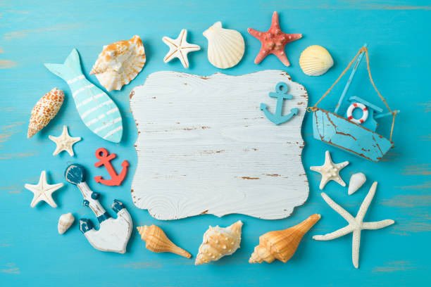 istock Empty wooden board, sailing boat and nautical decorations over blue background. Summer beach vacation concept. Flat lay, top view 1401265925