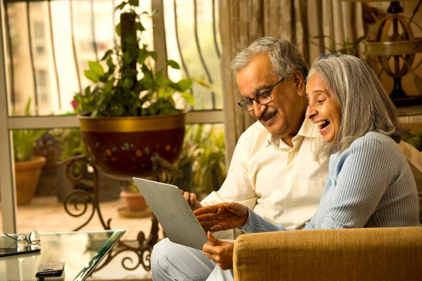 istock Old couple using laptop at home 1401267200