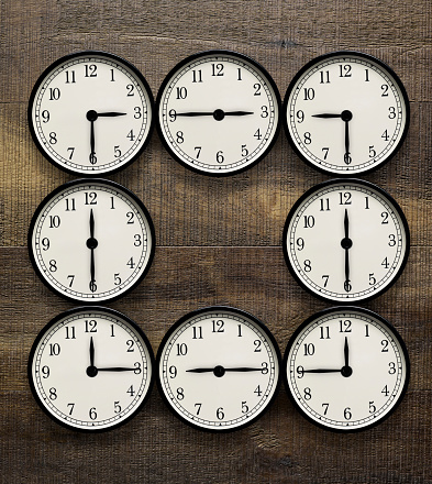 Round office clock showing twelve o'clock isolated on white background. Midnight or midday clock face