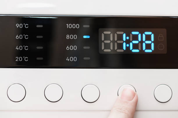 istock Washing machine display close up ,time remaining one hour 28 minutes during washing process. Finger selects wash mode. Abstract laundry programming backdrop 1401272304