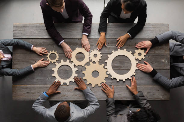istock Business people joining together gears 1401273879
