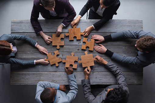 Business teamwork with white puzzle cooperation unity concept