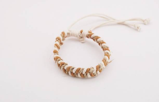 An isolated ethnic bracelet on white background. The bracelet is made off the various rope An isolated ethnic bracelet on white background. The bracelet is made off the various rope assiduity stock pictures, royalty-free photos & images