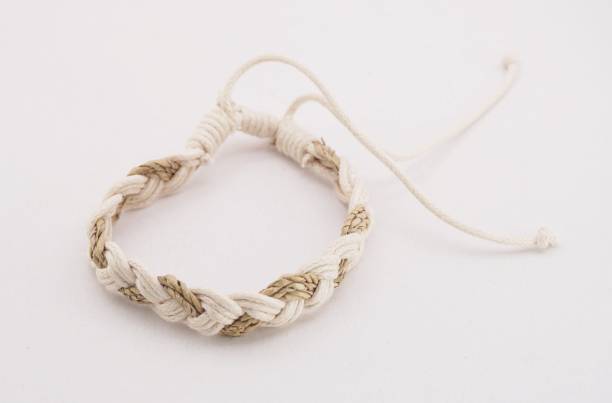 An isolated ethnic bracelet on white background. The bracelet is made off the various rope An isolated ethnic bracelet on white background. The bracelet is made off the various rope assiduity stock pictures, royalty-free photos & images