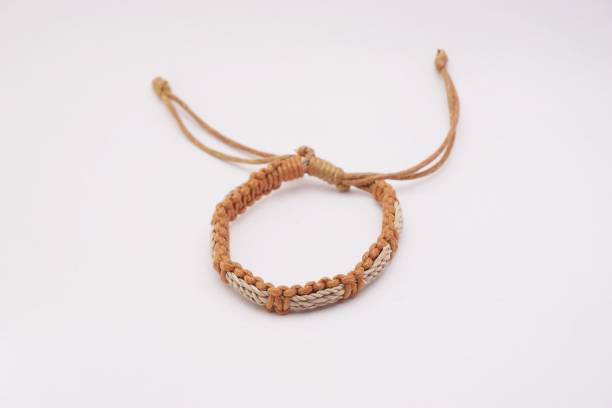 An isolated ethnic bracelet on white background. The bracelet is made off the various rope An isolated ethnic bracelet on white background. The bracelet is made off the various rope assiduity stock pictures, royalty-free photos & images