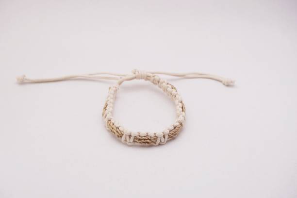 An isolated ethnic bracelet on white background. The bracelet is made off the various rope An isolated ethnic bracelet on white background. The bracelet is made off the various rope assiduity stock pictures, royalty-free photos & images