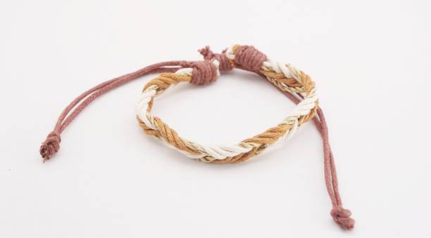 An isolated ethnic bracelet on white background. The bracelet is made off the various rope An isolated ethnic bracelet on white background. The bracelet is made off the various rope assiduity stock pictures, royalty-free photos & images