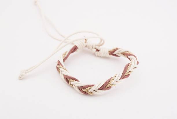 An isolated ethnic bracelet on white background. The bracelet is made off the various rope An isolated ethnic bracelet on white background. The bracelet is made off the various rope assiduity stock pictures, royalty-free photos & images