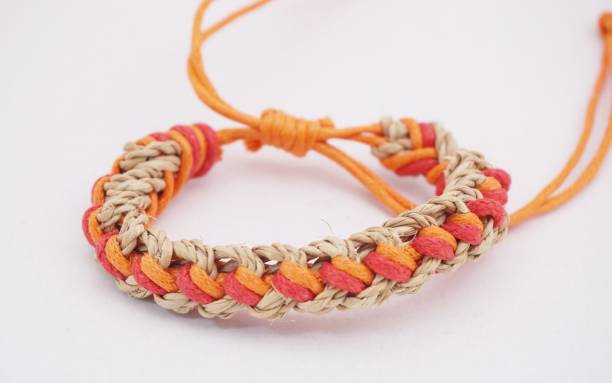 An isolated ethnic bracelet on white background. The bracelet is made off the various rope An isolated ethnic bracelet on white background. The bracelet is made off the various rope assiduity stock pictures, royalty-free photos & images